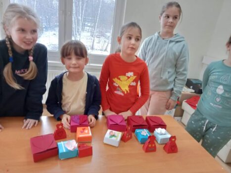 Grupa dzieci tworzy kolorowe pudełeczka na walentynki