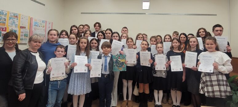 Grupa dzieci i młodzieży z dyplomami.